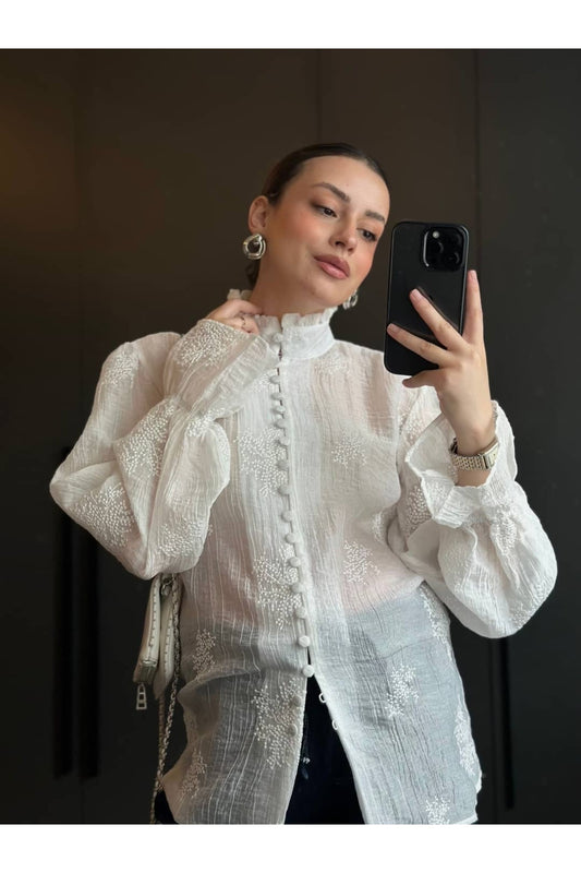Long-sleeved embroidered shirt with ruffles and elasticated cuffs.